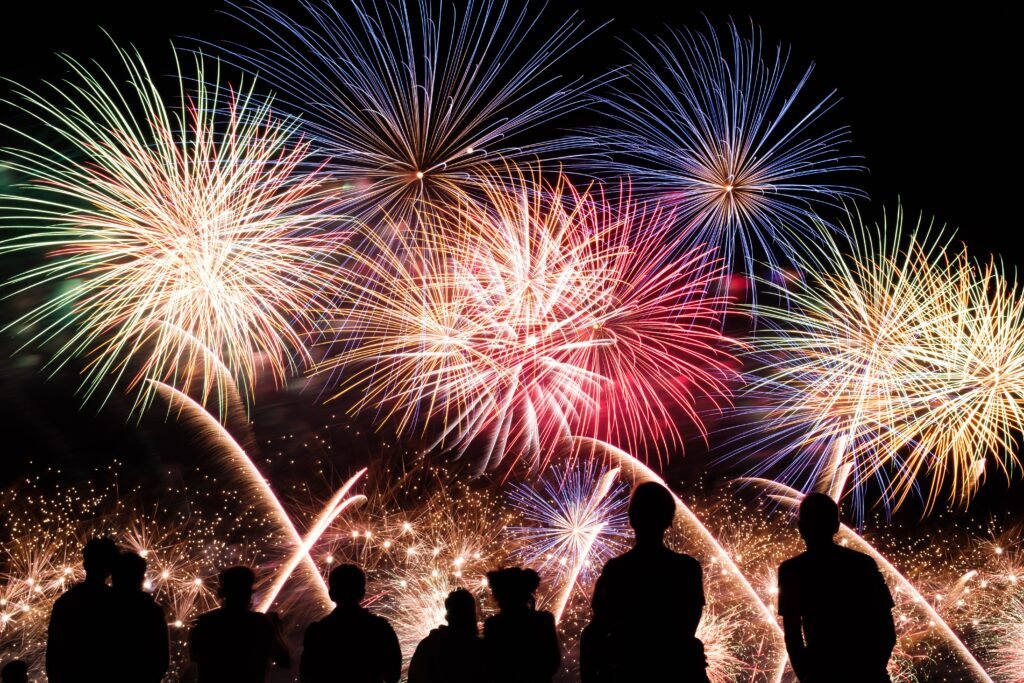 Fireworks display on Bonfire night in Perth with people watching in the foreground